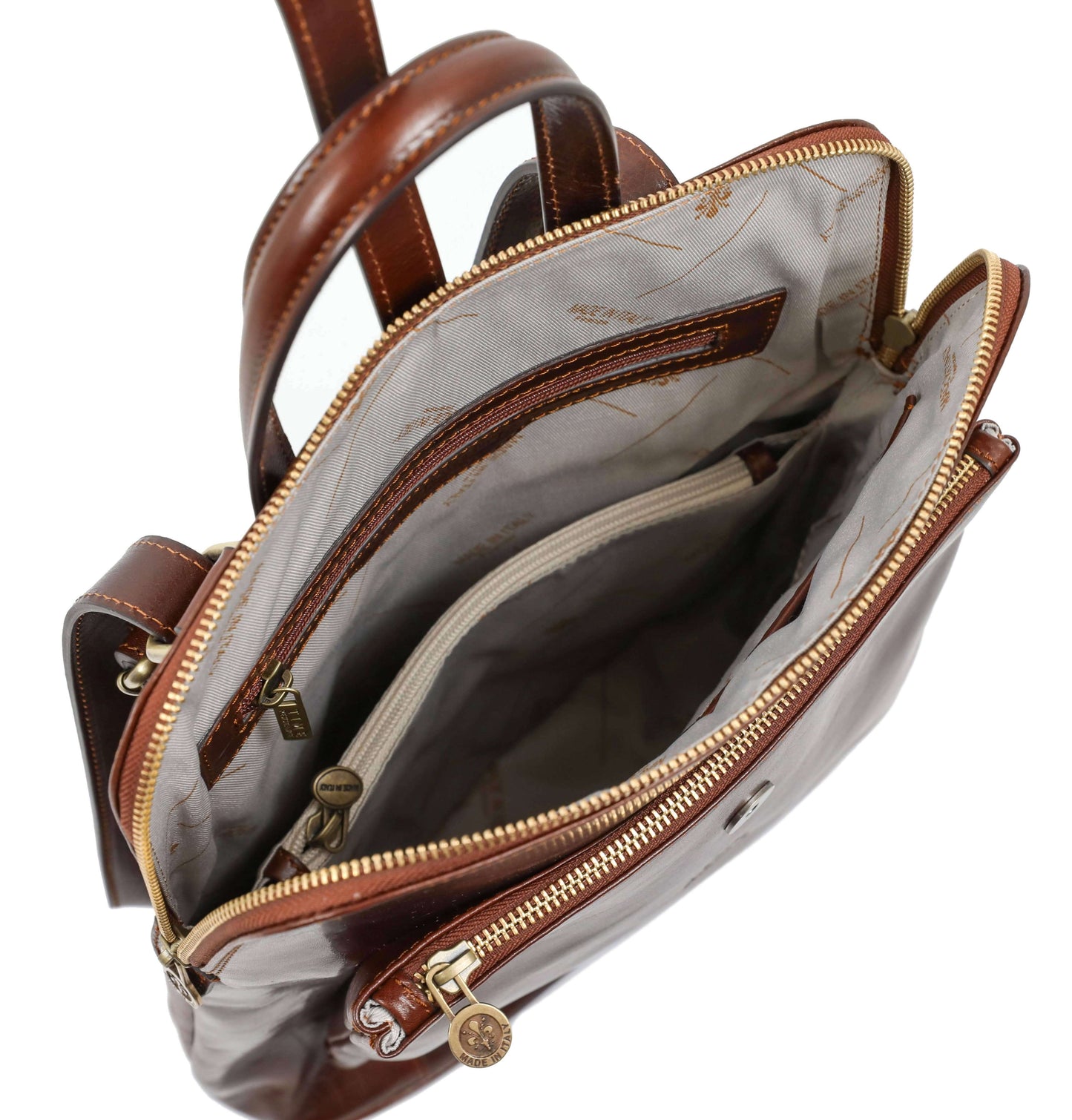 Brown leather handbag with gold zippers on a white background