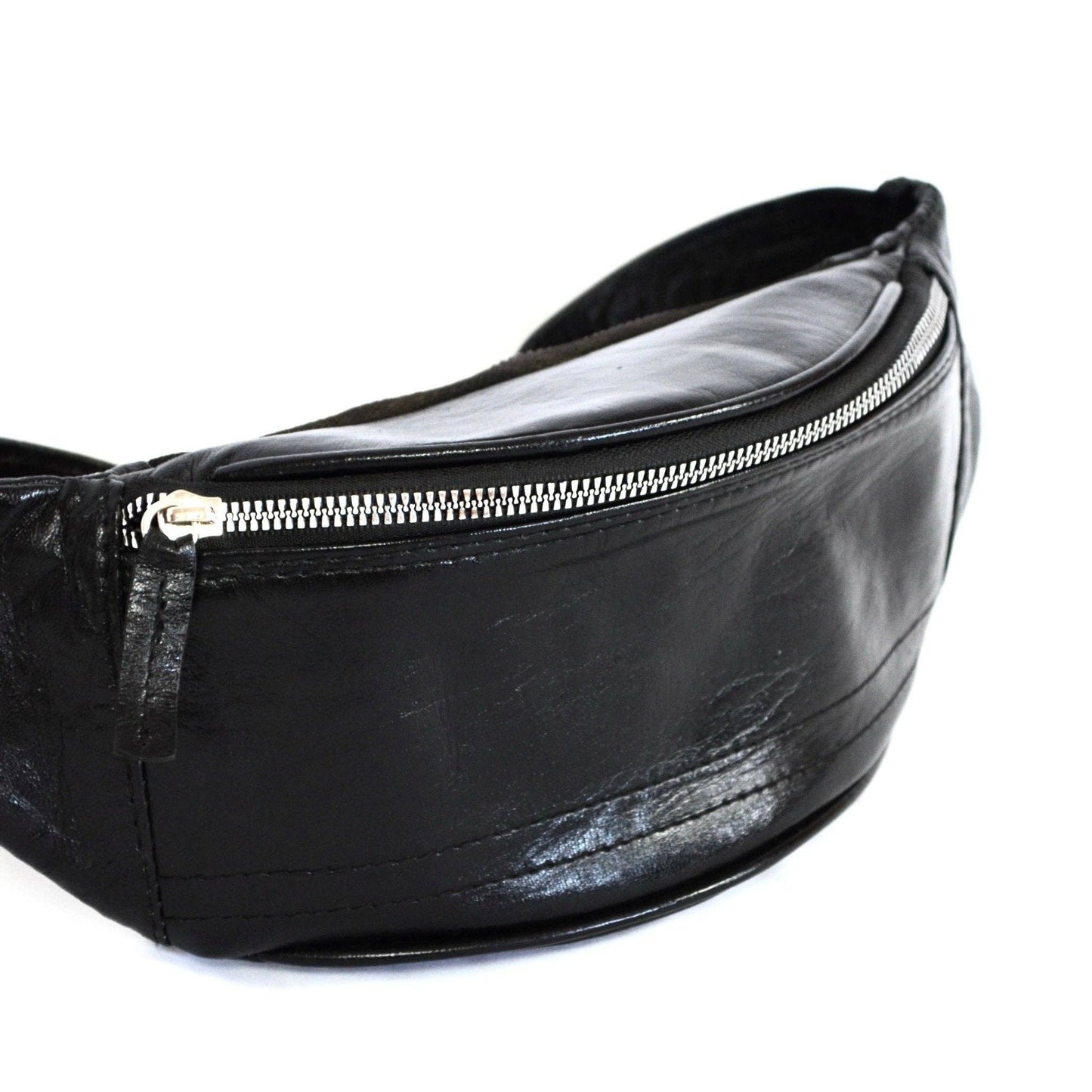 Black leather fanny pack with a silver zipper on a white background