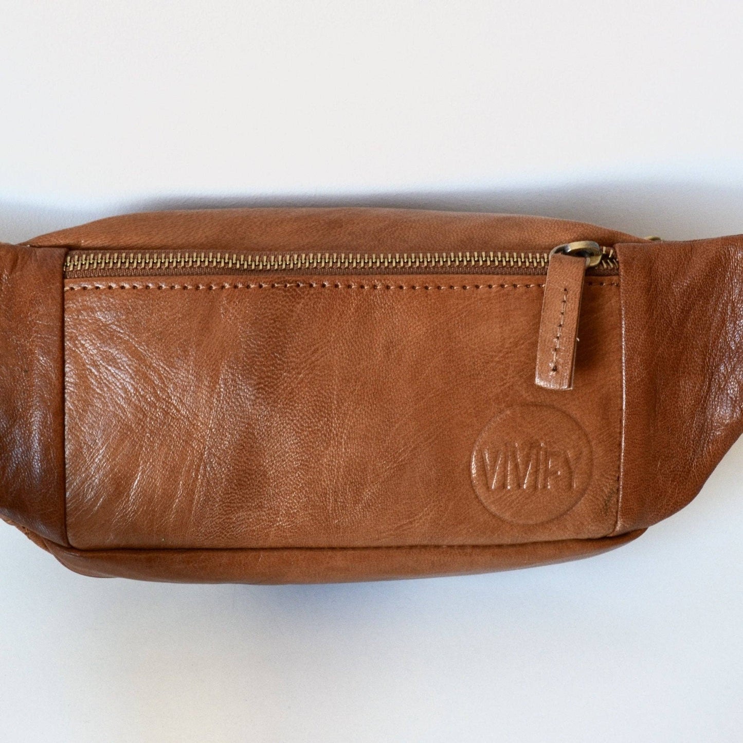 Brown leather waist bag with a visible brand logo on a white background