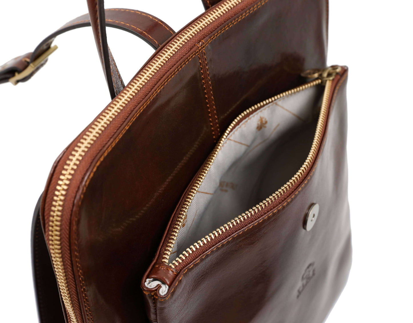 Interior view of cognac brown convertible leather backpack for women with zippers and lining.