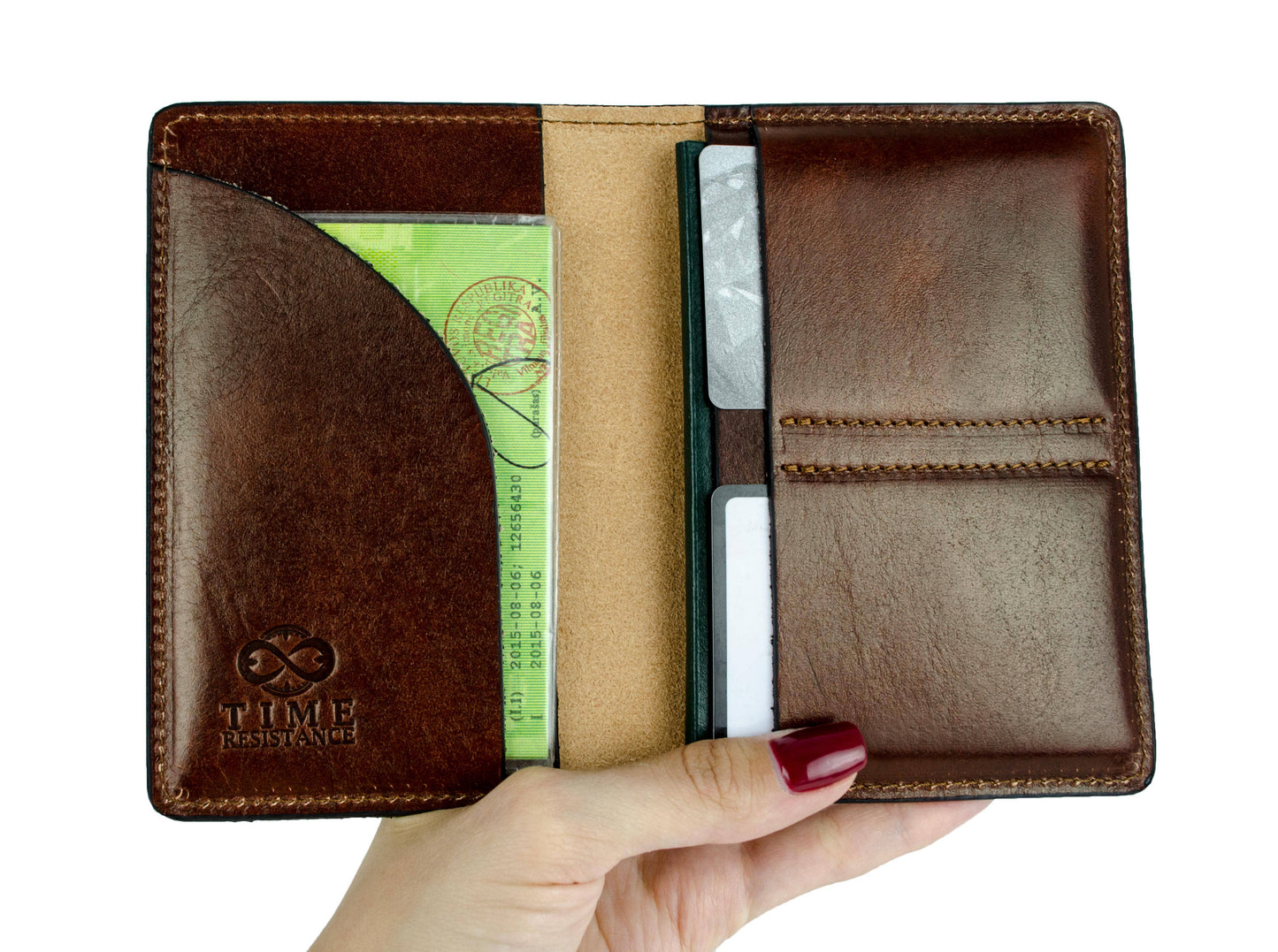 Brown leather wallet with card slots held by a hand on a white background