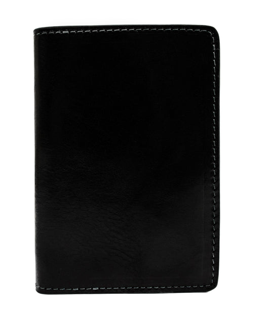 A brown leather passport holder with a classic design, featuring a flat surface and a slightly raised edge.